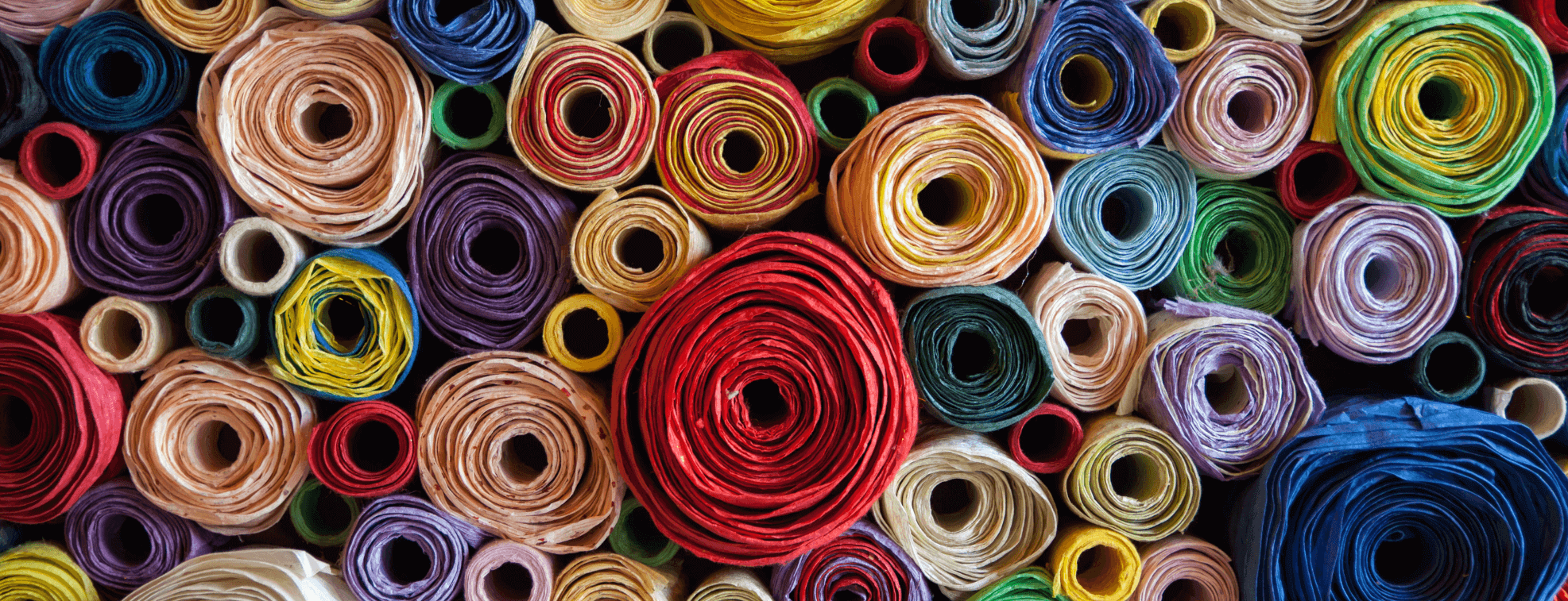 Carefully organized colorful rolls of textile